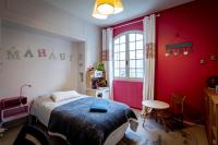a bedroom with a bed and a table and a window at Maison 5 chambres #8pers #Stationnement gratuit in Cognac