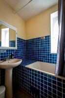 a blue tiled bathroom with a tub and a sink at Maison 5 chambres #8pers #Stationnement gratuit in Cognac