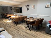 a dining room with wooden tables and chairs at The Roade House in Northampton