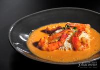 Un tazón de comida con camarones y arroz en una mesa. en Pure Monchique Hotel - Villa Termal Spa Resort - by Unlock Hotels, en Monchique