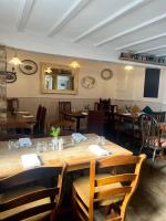 a dining room with a large wooden table and chairs at The Lion, Tredington in Shipston on Stour