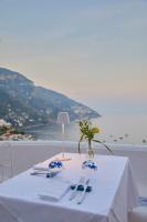 a white table with a view of the ocean at Hotel Conca d'Oro in Positano