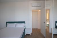 A bed or beds in a room at D Suite Fronte Mare