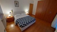 A bed or beds in a room at Appartamento Alessandro