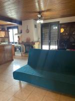 a living room with a blue couch in a kitchen at Superbe appartement en résidence avec patio in Villeneuve-lès-Maguelonne