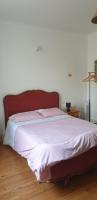 a bed with a red headboard in a bedroom at Le lorrain in Campagne-sur-Aude