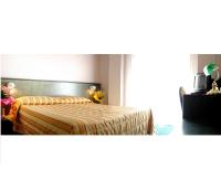 A bed or beds in a room at Hotel Capri Bardolino 3S