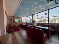 a restaurant with chairs and tables and a large window at Hotel New Era in Kathmandu