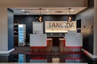 un salón con dos mesas y un cartel en la pared en Ramada by Wyndham Vineland Millville Area, en Vineland