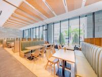 a restaurant with tables and chairs and windows at Keio Prelia Hotel Sapporo in Sapporo