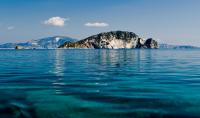 a small island in the middle of the water at Loukas Inn Family Resort in Keri