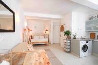 a kitchen and living room with a washer and dryer at Cosy studio situé en plein cœur du vieil antibes. in Antibes