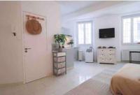 a bedroom with a bed and a dresser and a television at Cosy studio situé en plein cœur du vieil antibes. in Antibes