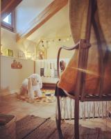 a room with a chair and a stuffed elephant at La Ferme de Philomène - Gîte en Périgord Noir in Sainte-Foy-de-Belvès