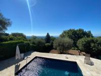 a swimming pool in the middle of a garden at Villa Vikel in Vence