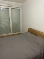 a bedroom with a bed and two windows with blinds at Myhotel19 in Noisy-le-Grand