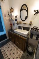 a bathroom with a sink and a mirror on the wall at Chambre Bounty cuisine privée, salle d&#39;eau, terrasse, garage in Olliergues