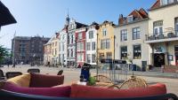 a table and chairs on a city street with buildings at Rijksmonument Havenzicht, met zeezicht, ligging direct aan zee en centrum in Vlissingen