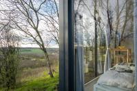 a bedroom with a window with a view of the countryside at Stüble Kabinok in Somogyhárságy