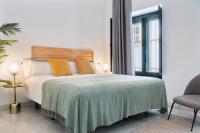 Postel nebo postele na pokoji v ubytování Suites Maestranza - Refinadores by Magno Apartments