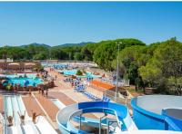 a large swimming pool with people at a resort at Camping Oasis village in Puget-sur-Argens