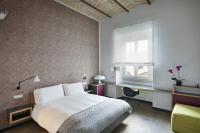 A bed or beds in a room at Atypical Rooms