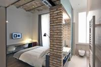 A bed or beds in a room at Atypical Rooms