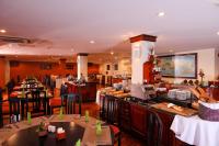 a restaurant with tables and chairs and a bar at Victoria Chau Doc Hotel in Chau Doc