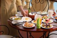 a table with plates of breakfast food on it at Victoria Chau Doc Hotel in Chau Doc
