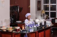 a woman is preparing food in a kitchen at Victoria Chau Doc Hotel in Chau Doc