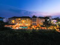 a large building with a swimming pool at night at Victoria Chau Doc Hotel in Chau Doc