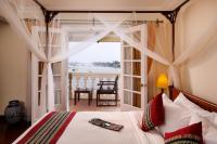a bedroom with a bed with a view of the ocean at Victoria Chau Doc Hotel in Chau Doc
