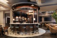 a bar in a restaurant with stools at Courtyard Seattle Downtown / Pioneer Square in Seattle