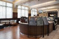 a restaurant with a counter with signs on it at Courtyard Seattle Downtown / Pioneer Square in Seattle