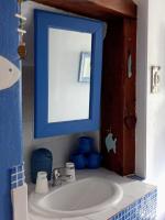 a bathroom with a sink and a blue mirror at Gîte Chez Dado &amp; Denis Saint Martin d&#39;Ardèche in Saint-Martin-dʼArdèche