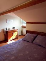 a bedroom with a bed and a dresser at Gîte Chez Dado &amp; Denis Saint Martin d&#39;Ardèche in Saint-Martin-dʼArdèche