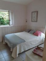 a bedroom with a bed and a window at Bastida in Saint-Macaire