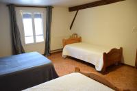 a room with two beds and a window at La Sente des Vignes in Hauteville