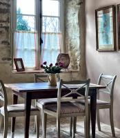a dining room with a wooden table and chairs at Maison Marie in Lagarde
