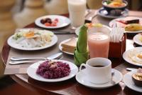 a table with plates of food and a cup of coffee at Victoria Chau Doc Hotel in Chau Doc