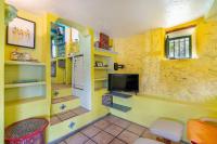 A television and/or entertainment centre at El Nido holiday cottage with pool