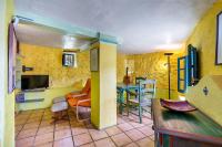 A television and/or entertainment centre at El Nido holiday cottage with pool