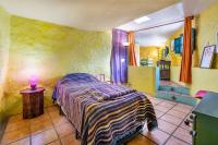 A bed or beds in a room at El Nido holiday cottage with pool