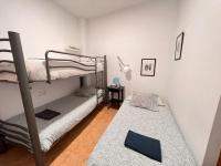 A bed or beds in a room at S2Plaza de la Merced especial grupos con parking