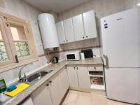 A kitchen or kitchenette at S2Plaza de la Merced especial grupos con parking