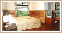 a bedroom with a bed and a television at Summer Trail B&amp;B in Guangfu