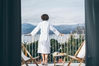 a woman standing on a balcony looking out at the mountains at Perle House in Fethiye