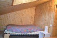 a room with a bed in a wooden cabin at Meublé en Drôme Provençale in Saint-Auban-sur-Ouvèze
