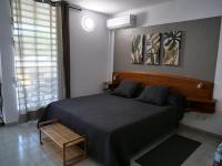 a bedroom with a large bed and a window at Village Kawann - Toumalacai 246 in Grand-Bourg