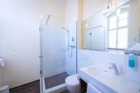 a white bathroom with a shower and a sink at Altstadthof Freinsheim in Freinsheim